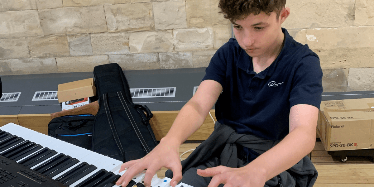 A boy playing a keyboard