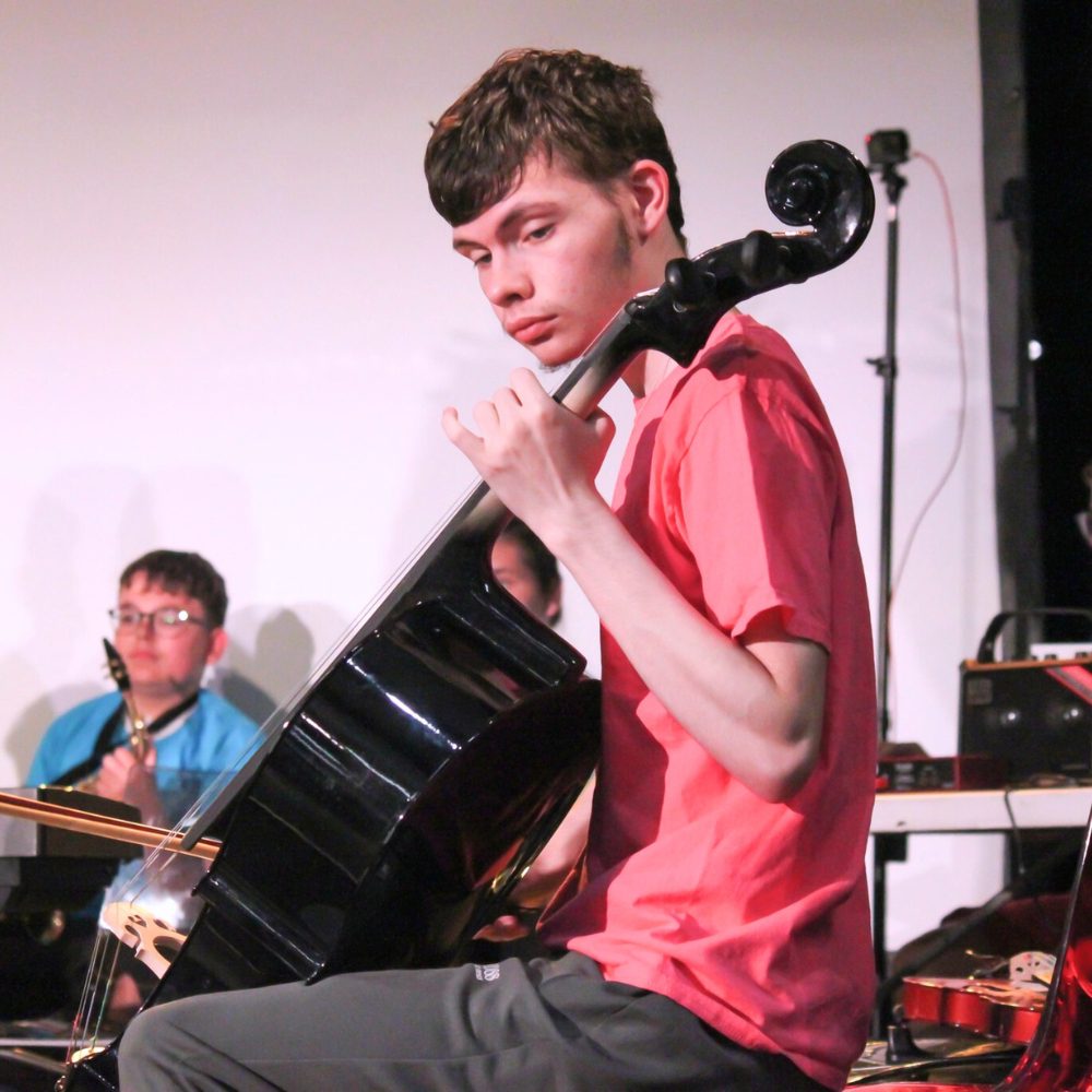 A young person playing cello