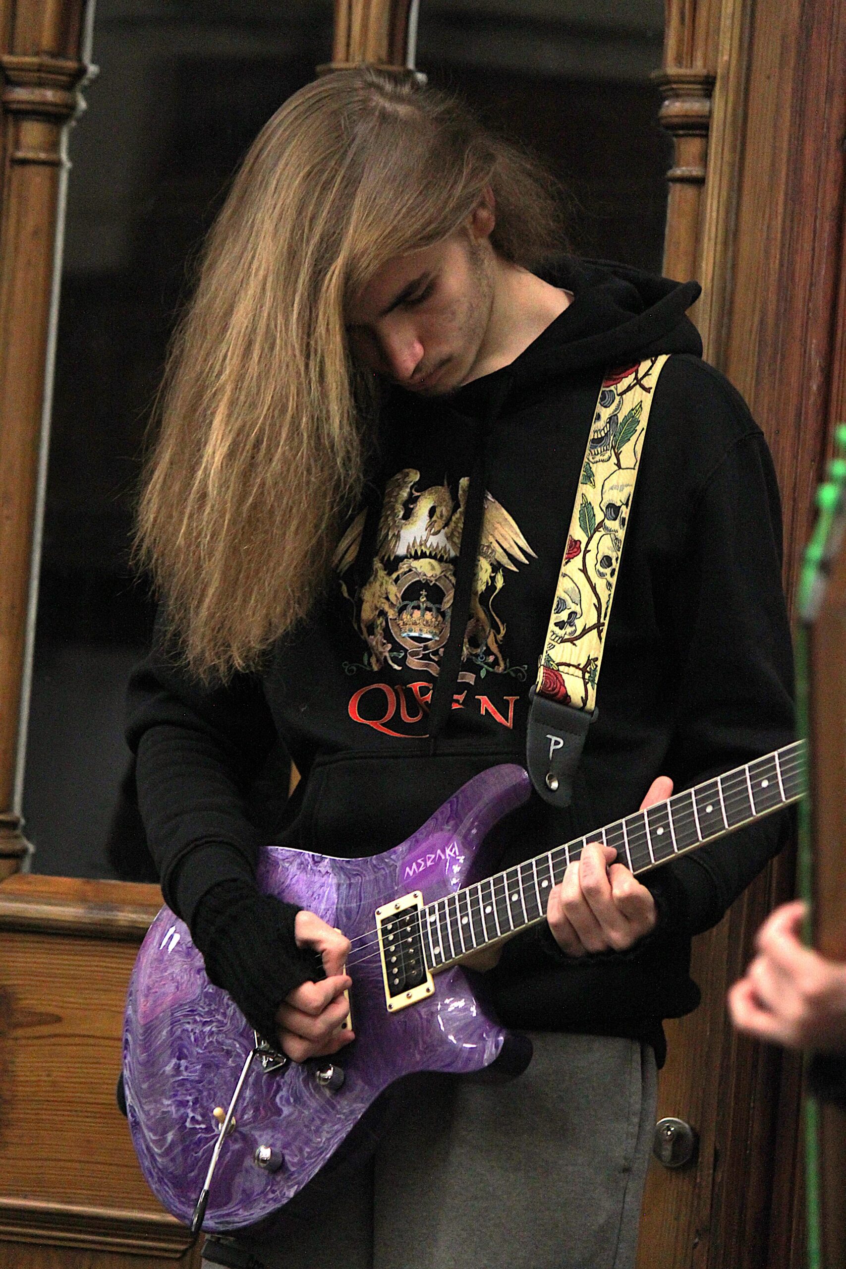 A young person playing the electric guitar