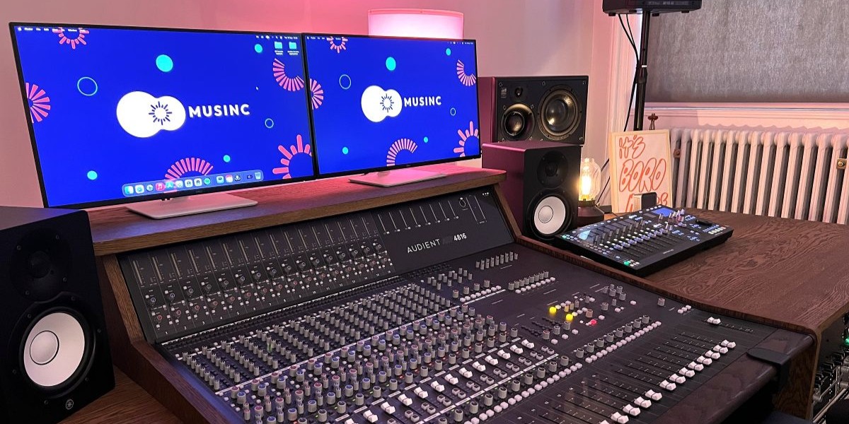 A recording studio with various musical instruments and a desktop computer