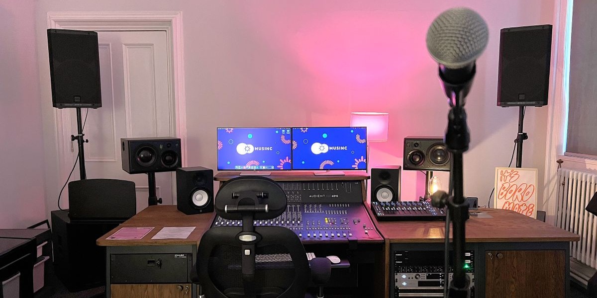 A recording studio with various musical instruments and a desktop computer