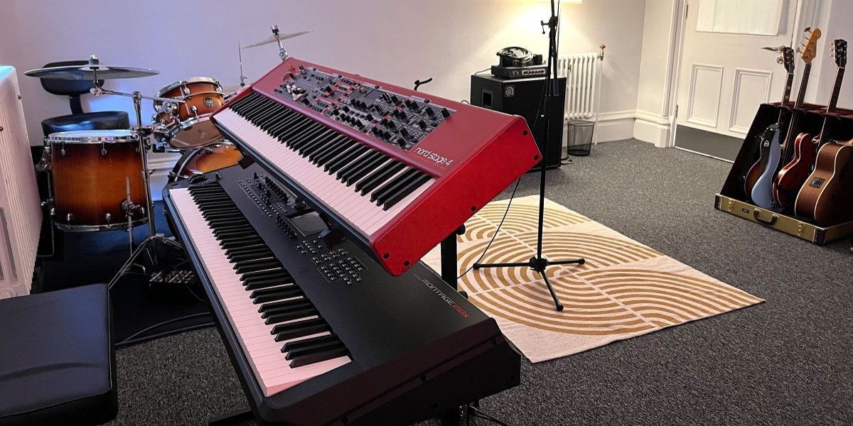 A recording studio with various musical instruments and a desktop computer